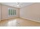This bedroom has hardwood floors, a ceiling fan, and natural light from the window at 3105 Birchton St, Johns Creek, GA 30022