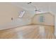 Large bonus room with hardwood floors, a ceiling fan, skylight, and natural light at 3105 Birchton St, Johns Creek, GA 30022