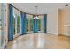 Bright dining room with hardwood floors, bay windows, and elegant blue drapes at 3105 Birchton St, Johns Creek, GA 30022