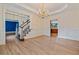 Open dining room featuring hardwood floors, wainscoting and chandelier at 3105 Birchton St, Johns Creek, GA 30022
