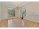 Dining room featuring hardwood floors, wainscoting, and a chandelier at 3105 Birchton St, Johns Creek, GA 30022