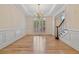 Dining room featuring hardwood floors, wainscoting, chandelier, and large windows at 3105 Birchton St, Johns Creek, GA 30022