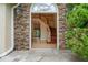 Elegant home entrance featuring stone accents, a wooden staircase, and a bright, inviting foyer at 3105 Birchton St, Johns Creek, GA 30022