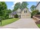 Charming two-story home featuring a manicured front lawn and a two-car garage at 3105 Birchton St, Johns Creek, GA 30022