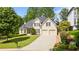 Charming two-story home featuring a manicured front lawn and a two-car garage at 3105 Birchton St, Johns Creek, GA 30022