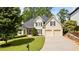 Charming two-story home with manicured lawn, two car garage, and inviting curb appeal at 3105 Birchton St, Johns Creek, GA 30022