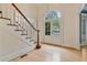 Foyer featuring hardwood floors, stairs, an arched window and double front doors at 3105 Birchton St, Johns Creek, GA 30022