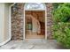 Welcoming foyer with stone accents leads to an elegant staircase and hardwood floors at 3105 Birchton St, Johns Creek, GA 30022