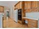 Kitchen area features appliances, wooden cabinets, and white countertops at 3105 Birchton St, Johns Creek, GA 30022