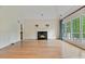 Living room featuring hardwood floors, fireplace, a wall of windows, and high ceilings at 3105 Birchton St, Johns Creek, GA 30022