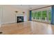 Bright living room featuring hardwood floors, fireplace, and a wall of windows at 3105 Birchton St, Johns Creek, GA 30022
