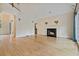 Bright living room with hardwood floors, fireplace, and large windows with blue drapes at 3105 Birchton St, Johns Creek, GA 30022