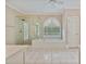 Elegant bathroom features a soaking tub, shower, and arched window at 3105 Birchton St, Johns Creek, GA 30022