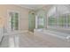 Elegant bathroom features a soaking tub, shower, and bright, natural light at 3105 Birchton St, Johns Creek, GA 30022