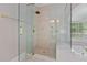 Glass shower in bathroom with brass fixtures and elegant design at 3105 Birchton St, Johns Creek, GA 30022
