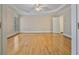 Spacious main bedroom with hardwood floors, tray ceiling, and bright windows at 3105 Birchton St, Johns Creek, GA 30022