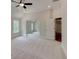Bright bedroom with neutral carpeting, a ceiling fan, and an attached bonus room at 3294 Mill Forest Dr, Conyers, GA 30094