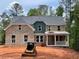 Beautiful two-story brick home with a welcoming front porch and gray trim at 3294 Mill Forest Dr, Conyers, GA 30094