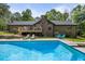 Backyard features an in-ground pool, deck, and lush landscaping at 3400 Bonds Lake Nw Rd, Conyers, GA 30012