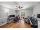 Comfortable bedroom featuring hardwood floors, a ceiling fan, and neutral wall paint at 3400 Bonds Lake Nw Rd, Conyers, GA 30012