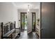 Elegant foyer with a dark tile floor, white walls, and a view of the front door that leads out to the porch at 3400 Bonds Lake Nw Rd, Conyers, GA 30012