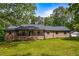 Inviting brick home with a spacious front porch, complemented by a well-manicured lawn and mature shade trees at 3400 Bonds Lake Nw Rd, Conyers, GA 30012