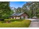Charming single-story brick home featuring an attached two-car garage and a sprawling front lawn with mature trees at 3400 Bonds Lake Nw Rd, Conyers, GA 30012