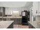 Kitchen with granite countertops, stainless steel appliances, dark cabinets, and white walls that create a modern look at 3400 Bonds Lake Nw Rd, Conyers, GA 30012