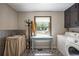 Bright laundry room with detailed flooring, stylish sink, and large window at 3400 Bonds Lake Nw Rd, Conyers, GA 30012