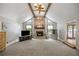 A spacious living room is brightened by natural light, features a brick fireplace and carpeted floor at 3400 Bonds Lake Nw Rd, Conyers, GA 30012