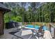 Outdoor living space featuring a pool, deck, and ample seating at 3400 Bonds Lake Nw Rd, Conyers, GA 30012