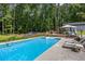 Enjoy the in-ground pool, lounge chairs, and gazebo in this backyard oasis at 3400 Bonds Lake Nw Rd, Conyers, GA 30012