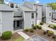 Inviting townhome with gray siding, manicured landscaping, and parking space at 1021 Riverbend Club Se Dr, Atlanta, GA 30339