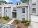 Charming gray townhome with well-maintained landscaping and a one-car garage at 1021 Riverbend Club Se Dr, Atlanta, GA 30339