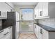 Kitchen area featuring stainless steel refrigerator and ample natural light at 1021 Riverbend Club Se Dr, Atlanta, GA 30339