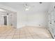 Neutral living room with ceiling fan, tile floors, and double doors at 1021 Riverbend Club Se Dr, Atlanta, GA 30339