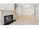 Open-concept living and dining area with fireplace, built-ins, and tile floors at 1021 Riverbend Club Se Dr, Atlanta, GA 30339