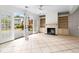 Cozy living room with fireplace, built-in shelves, and access to outdoor deck at 1021 Riverbend Club Se Dr, Atlanta, GA 30339