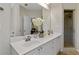 Bathroom featuring double sinks, quartz countertops and a glass shower at 2400 Cumberland Se Pkwy # 803, Atlanta, GA 30339