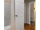 Hallway view of bathroom with white bath tub and tile flooring at 2400 Cumberland Se Pkwy # 803, Atlanta, GA 30339