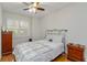Cozy bedroom with a ceiling fan, wood floors, and a window with plantation shutters at 2400 Cumberland Se Pkwy # 803, Atlanta, GA 30339