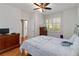 Bright bedroom with a ceiling fan, a dresser and a door to the bathroom at 2400 Cumberland Se Pkwy # 803, Atlanta, GA 30339