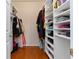 Organized walk-in closet featuring built-in shelving for shoes, clothes, and accessories at 2400 Cumberland Se Pkwy # 803, Atlanta, GA 30339