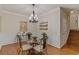 Cozy dining room featuring a glass table, chandelier, and wainscoting at 2400 Cumberland Se Pkwy # 803, Atlanta, GA 30339