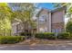 Well-maintained townhouse exterior featuring stone accents, mature trees, and lush green landscaping at 2400 Cumberland Se Pkwy # 803, Atlanta, GA 30339