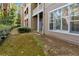 Exterior view of a multi-level home with a covered patio area and manicured lawn at 2400 Cumberland Se Pkwy # 803, Atlanta, GA 30339