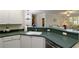 Open kitchen view with sink and bar, flowing into a sunny living area at 2400 Cumberland Se Pkwy # 803, Atlanta, GA 30339