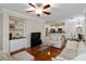 Spacious living room with hardwood floors, built-in shelving, and views to the kitchen and dining area at 2400 Cumberland Se Pkwy # 803, Atlanta, GA 30339