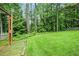 Manicured backyard featuring a large green lawn and privacy from mature trees at 3320 Woodleaf Way, Marietta, GA 30062