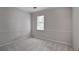 Bright bedroom featuring neutral carpeting, crown molding, and a window with views of the outdoors at 3320 Woodleaf Way, Marietta, GA 30062
